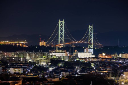 Photo for Akashi Kaikyo Suspension Bridge and Apartment Buildings Lit at Night. High quality photo - Royalty Free Image