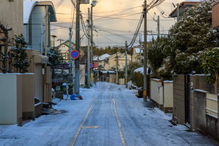 Photo for Tire tracks in light snow on street in quiet residential neighborhood at dawn. High quality photo - Royalty Free Image