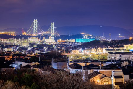 Photo for Suspension Bridge Towers Over Houses in Residential Neighborhood at Night. High quality photo - Royalty Free Image