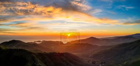 Photo for Sunset over ocean with rugged mountain coast and beautiful color in clouds. High quality photo - Royalty Free Image