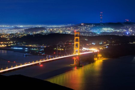 Photo for Golden Gate Bridge and lights from hilly city of San Francisco at night. High quality photo - Royalty Free Image