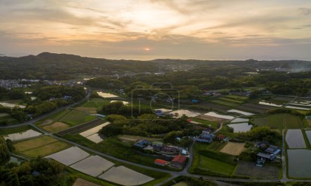 Photo for Sunset sky over houses and rice fields in traditional farming village. High quality photo - Royalty Free Image