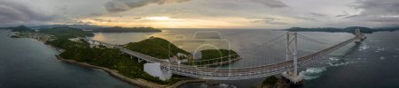 Photo for Panoramic aerial view of suspension bridge on coast at sunset. High quality photo - Royalty Free Image