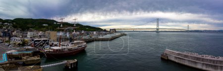 Photo for Panoramic view of historic sailing ship anchored at port by modern bridge. High quality photo - Royalty Free Image