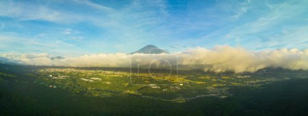 Photo for Panoramic view of Mt. Fuji peak above clouds and green summer landscape. High quality photo - Royalty Free Image