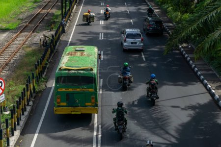 Photo for Surabaya, Indonesia - 18 nov 2021: motocycle and cars passing by Ahmad Yani street in Surabaya Indoenesia. People are going to work - Royalty Free Image