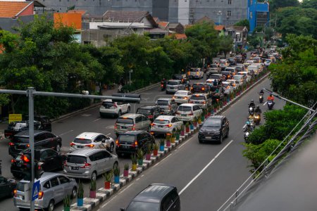 Photo for Surabaya, Indonesia - 18 nov 2021: Cars and motorcycles in traffic jam at Jemur Andayani street in Suarabaya Indonesia. cars in line - Royalty Free Image
