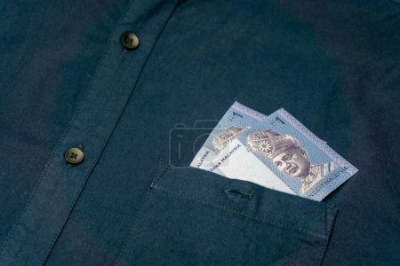 Photo for Close up of malaysian ringgit in  shirt pocket. Banknotes of Malaysia. - Royalty Free Image