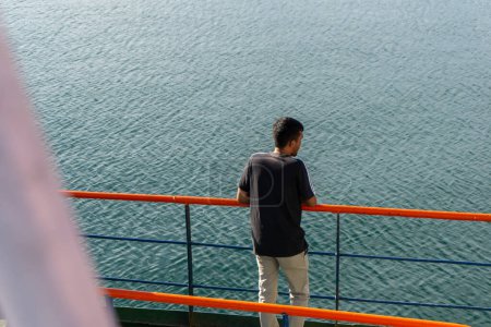 Photo for Sabang, Indonesia - June 01 2023: Man standing on the ship. Passengers on ferry boat headed to sabang island. KMP BRR - Royalty Free Image