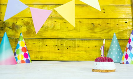 Photo for Colorful card happy birthday with festive decorations with cake and burning candles. Copy space. Beautiful happy birthday background on the background of yellow boards with a number of candles number 1 - Royalty Free Image