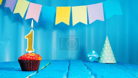 Photo for Happy birthday card with a muffin decorated with a festive cake and burning candles. Copy space. Beautiful background happy birthday on the background of blue boards with a number of candles number 1. - Royalty Free Image