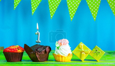 Photo for Happy birthday colorful background with decorations with festive garlands with pies and muffins and gift boxes with copy space. Beautiful happy birthday background with number 1 candles - Royalty Free Image