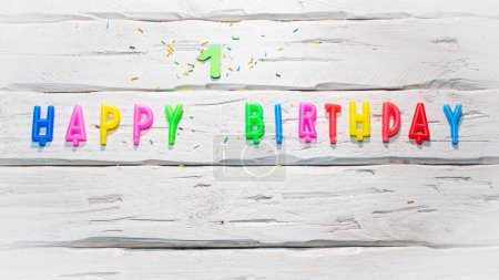 Photo for Top view of happy birthday candle numbers copy space on wooden white pastel boards. Beautiful birthday card with number 1 - Royalty Free Image