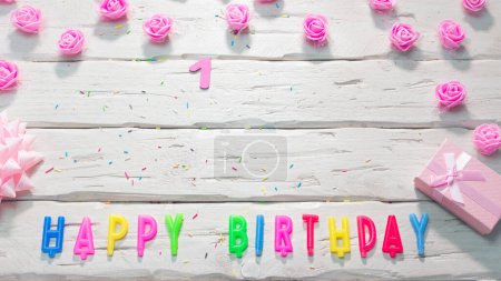 Photo for Top view of happy birthday candle letters for a girl in pink shades with beautiful rose flowers, postcard congratulation copy space on wooden boards. Beautiful birthday card number 1 - Royalty Free Image