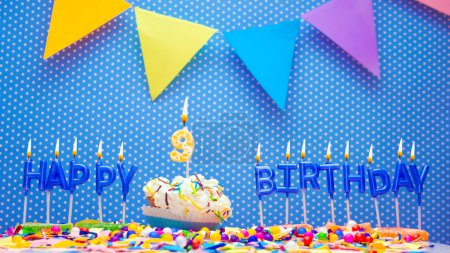 A word made from the letters of happy birthday candles. Copy space Happy birthday greetings for 9 years old, lit candles with holiday decorations. Beautiful holiday card
