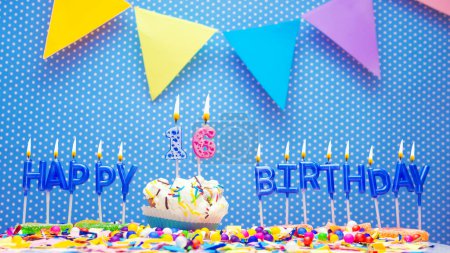 Téléchargez les photos : Happy birthday candle letter word for years old. Copy space Happy birthday greetings for 16  years, lit candles with holiday decorations. Beautiful holiday card. - en image libre de droit