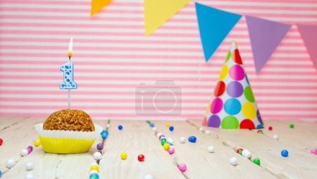 Photo for Happy birthday for 1 year old. Festive background with muffin. Copy a birthday card for a one year old baby on a pink background. - Royalty Free Image