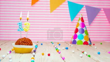 Photo for Happy birthday for 13 years old. Festive background with muffin. Copy the birthday card for a thirteen year old on a pink background - Royalty Free Image