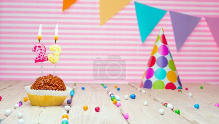 Foto de Happy birthday for 23 years old. Festive background with muffin. Copy the birthday card for a twenty-three year old on a pink background - Imagen libre de derechos