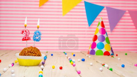 Foto de Happy birthday for 28 years old. Festive background with muffin. Copy a birthday card for a twenty-eight year old on a pink background - Imagen libre de derechos