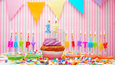 Photo for Happy birthday number 17. On a pink background, congratulations on the birthday of seventeen years old. Muffins with pink cream with a burning candle. Copy space - Royalty Free Image