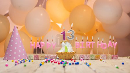 Photo for Beautiful background happy birthday number 13 with burning candles, birthday candles pink letters for a thirteen year old child. Festive background with balloons - Royalty Free Image