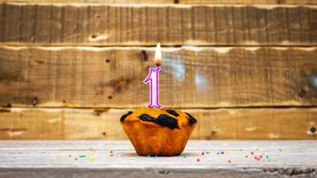 Photo for Muffin with candle burning background for anniversary. Greeting card for the holiday. Happy birthday background minimalist copy space 1 - Royalty Free Image