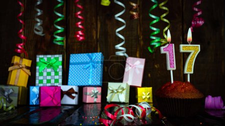 Photo for Party birthday background with number  17. Beautiful background anniversary copy space with burning candles. Gift boxes with decorations. - Royalty Free Image