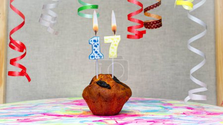 Photo for Happy birthday background with muffin with beautiful decorations with number candles  17. Colorful festive card happy birthday with a number. Anniversary copy space - Royalty Free Image