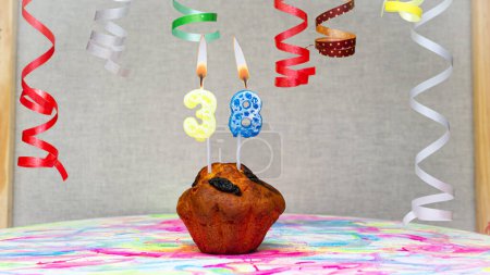 Foto de Happy birthday background with muffin with beautiful decorations with number candles  38. Colorful festive card happy birthday with a number. Anniversary copy space - Imagen libre de derechos