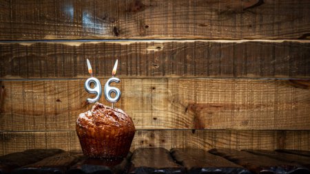 Foto de Background happy birthday pie or muffin with candles burning digit number  96. Festive card Happy Birthday on the background of vintage boards. Anniversary copy space - Imagen libre de derechos
