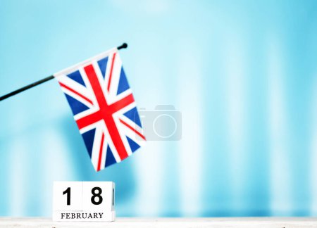 February calendar with British flag with number 18. Calendar cubes with numbers. Space copy.