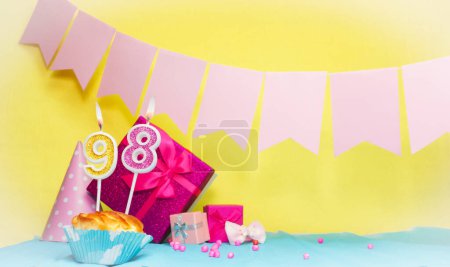 Date of birth with cake and number  98. Colorful card happy birthday for a girl. Copy space. Anniversary card pink. Congratulations on the decorations are beautiful.