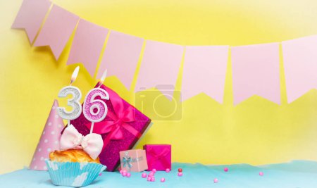Date of birth with cake and number  36. Colorful card happy birthday for a girl. Copy space. Anniversary card pink. Congratulations on the decorations are beautiful.