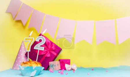 Date of birth with cake and number  72. Colorful card happy birthday for a girl. Copy space. Anniversary card pink. Congratulations on the decorations are beautiful.