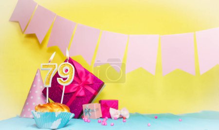 Date of birth with cake and number  79. Colorful card happy birthday for a girl. Copy space. Anniversary card pink. Congratulations on the decorations are beautiful.