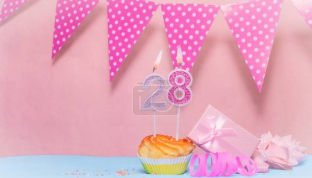 Date of Birth  28. Greeting card in pink shades. Anniversary candle numbers. Happy birthday girl, polka dot garland decoration. Copy space.