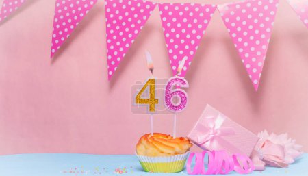 Fecha de nacimiento 46. Tarjeta de felicitación en tonos rosados. Números de velas de aniversario. Chica feliz cumpleaños, decoración de guirnalda de lunares. Copiar espacio.