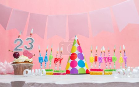 Background date of birth number  23. Anniversary. Beautiful festive background with candles for a girl. Women's congratulations postcard. Happy birthday in pink.