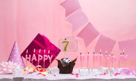 Background card date of birth for a girl  7. Anniversary. Beautiful festive background with candles. Women's congratulations card with a cake. Happy birthday in pink. copy space