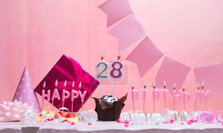 Background card date of birth for a girl  28. Anniversary. Beautiful festive background with candles. Women's congratulations card with a cake. Happy birthday in pink. copy space