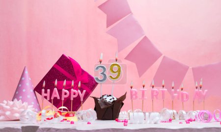 Background card date of birth for a girl  39. Anniversary. Beautiful festive background with candles. Women's congratulations card with a cake. Happy birthday in pink. copy space