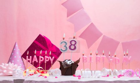 Background card date of birth for a girl  38. Anniversary. Beautiful festive background with candles. Women's congratulations card with a cake. Happy birthday in pink. copy space