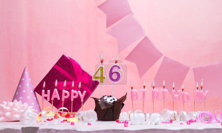 Background card date of birth for a girl  46. Anniversary. Beautiful festive background with candles. Women's congratulations card with a cake. Happy birthday in pink. copy space