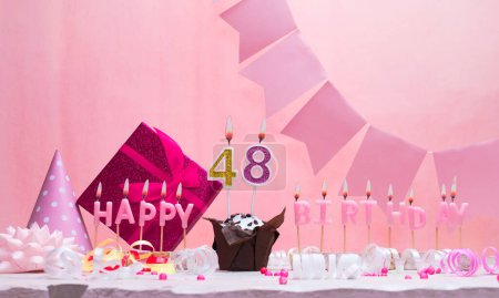Background card date of birth for a girl  48. Anniversary. Beautiful festive background with candles. Women's congratulations card with a cake. Happy birthday in pink. copy space
