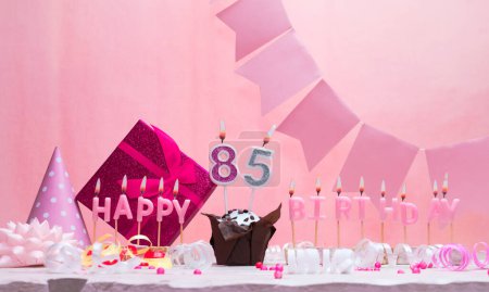 Background card date of birth for a girl  85. Anniversary. Beautiful festive background with candles. Women's congratulations card with a cake. Happy birthday in pink. copy space