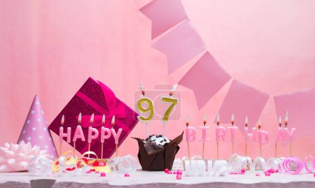 Background card date of birth for a girl  97. Anniversary. Beautiful festive background with candles. Women's congratulations card with a cake. Happy birthday in pink. copy space