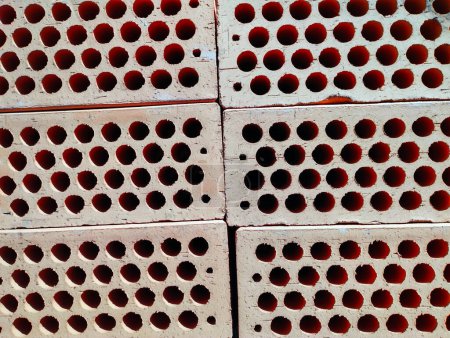 Téléchargez les photos : Brique rouge sur une palette en bois. Construction brique d'argile rouge. Brique avec un trou. - en image libre de droit
