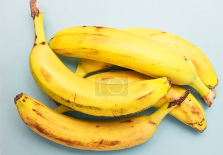 Sträuße reifer Bananen auf buntem Hintergrund. Strickbananen. Ansicht von oben