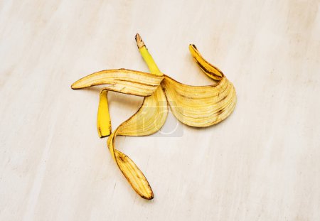 Banana peel on white wooden table